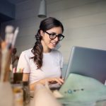 Young girl typing on laptop