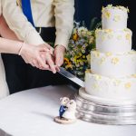 Couple cutting wedding cake