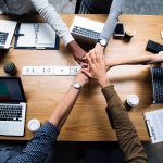 Group of people doing a hand huddle