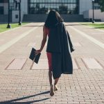 Girl walking with graduation cap